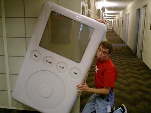 Ned Holbrook sidetalking on a giant iPod